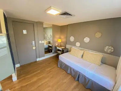 Uma cama ou camas num quarto em Magna Praia Hotel