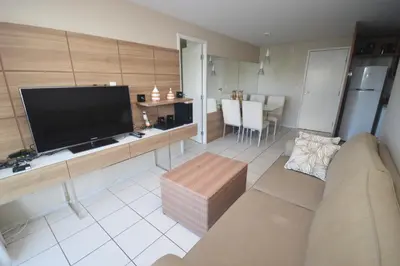 Uma televisão e/ou sistema de entretenimento em Praia Iracema Apartment