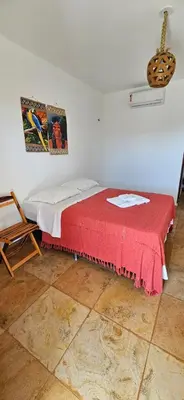 Uma cama ou camas num quarto em Mansão Guajiru Suítes