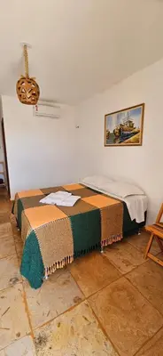 Uma cama ou camas num quarto em Mansão Guajiru Suítes