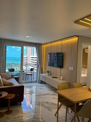 Uma televisão e/ou sistema de entretenimento em Vista Mar incrível com 2 Quartos Beira Mar Fortaleza