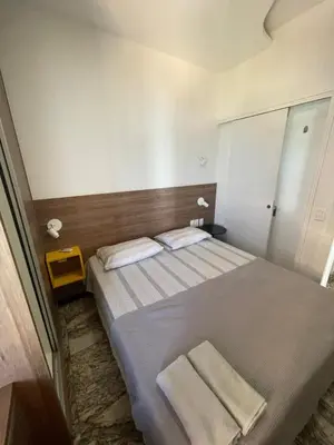 Uma cama ou camas num quarto em Villa Costeira Flat