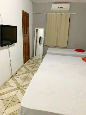 Uma cama ou camas num quarto em Pousada Estilo Brasil