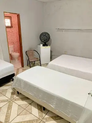 Uma cama ou camas num quarto em Pousada Estilo Brasil