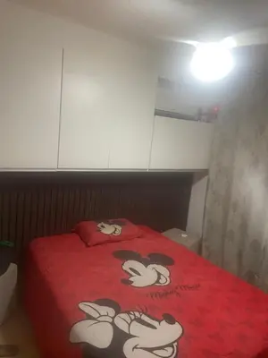 Uma cama ou camas num quarto em Carlos meu ape