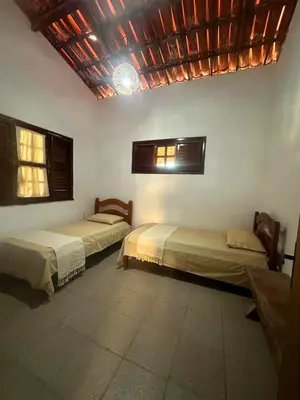 Uma cama ou camas num quarto em Casa de Praia - Praia do Presídio
