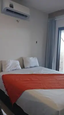 Uma cama ou camas num quarto em Apartamento Sobre as Ondas