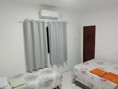 Uma cama ou camas num quarto em Casa Praia Paracuru - Orquídeas de Célia
