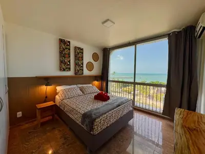 Uma cama ou camas num quarto em Beira Mar - Apartamento COM VISTA e SEM VISTA MAR