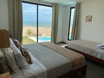 Uma cama ou camas num quarto em Vila éden praia suítes