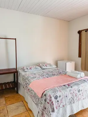 Uma cama ou camas num quarto em Pousada Recanto dos Ventos