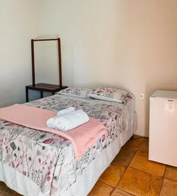 Uma cama ou camas num quarto em Pousada Recanto dos Ventos