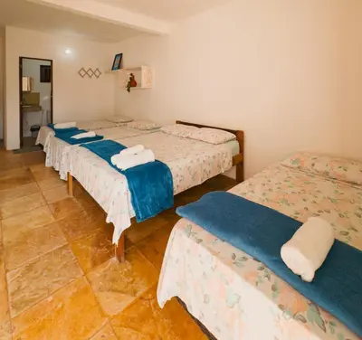 Uma cama ou camas num quarto em Pousada Recanto dos Ventos