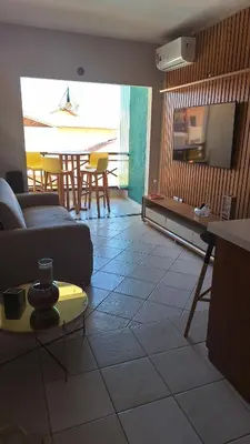 Uma área de estar em Apt moderno Porto das Dunas