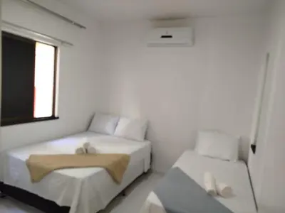 Uma cama ou camas num quarto em Frente mar cumbuco