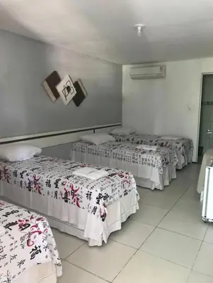Uma cama ou camas num quarto em Hotel Dom Cláudio