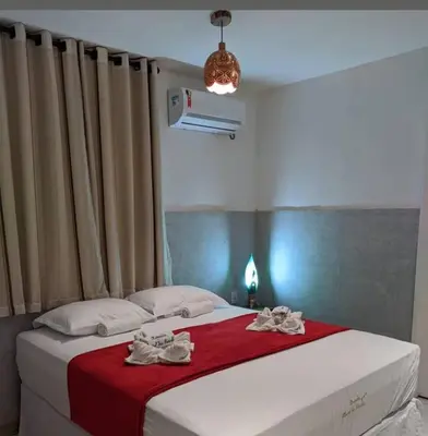 Uma cama ou camas num quarto em Pousada pontal das estrelas