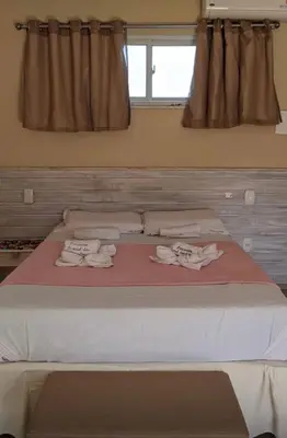 Uma cama ou camas num quarto em Pousada pontal das estrelas