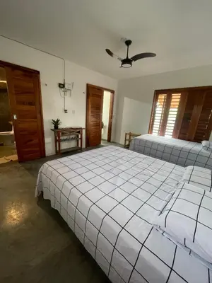 Uma cama ou camas num quarto em Aquarela Lofts em Icaraizinho
