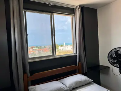 Uma cama ou camas num quarto em Vista mar, piscina, na praia do futuro, com Ar condicionado e Wi-Fi