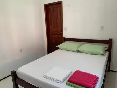 Uma cama ou camas num quarto em Chalés de Morro Branco