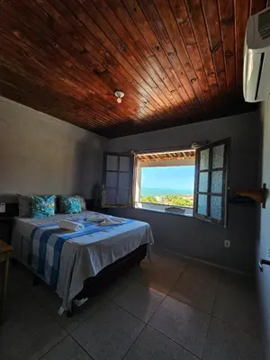 Uma cama ou camas num quarto em Casa sol nascente
