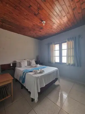 Uma cama ou camas num quarto em Casa sol nascente