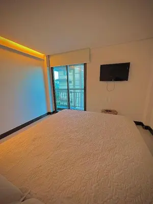 Uma cama ou camas num quarto em Bangalô Duplex Exclusivo em Manhattan Riviera