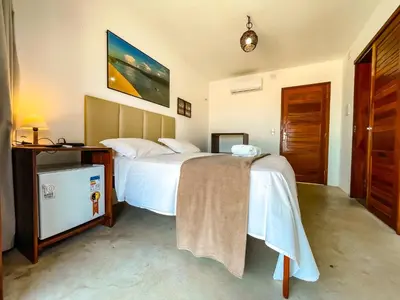 Uma cama ou camas num quarto em Vila Bertini Icaraizinho