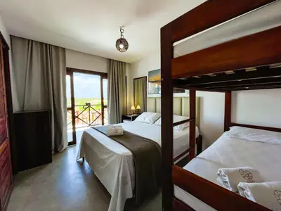 Uma cama ou camas num quarto em Vila Bertini Icaraizinho