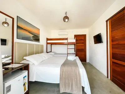 Uma cama ou camas num quarto em Vila Bertini Icaraizinho