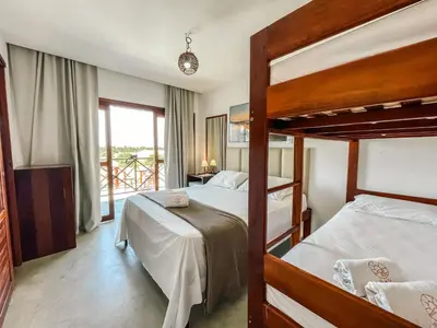 Uma cama ou camas num quarto em Vila Bertini Icaraizinho