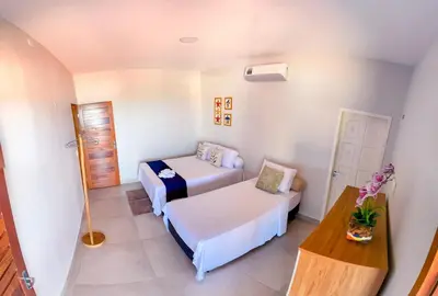 Uma cama ou camas num quarto em Casa Refúgio Tropical