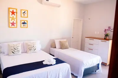 Uma cama ou camas num quarto em Casa Refúgio Tropical