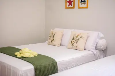 Uma cama ou camas num quarto em Casa Refúgio Tropical