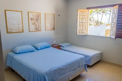 Uma cama ou camas num quarto em Belíssima casa na praia do Morro Branco
