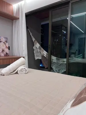 Uma cama ou camas num quarto em Studio Pérola com Rooftop Vista para o Mar