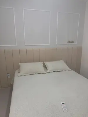 Uma cama ou camas num quarto em Apartamento novo 01