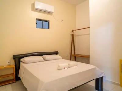 Uma cama ou camas num quarto em Suítes Pe na Areia