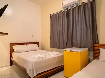 Uma cama ou camas num quarto em Suítes Pe na Areia
