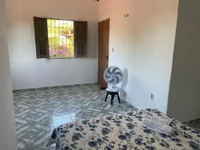 Uma cama ou camas num quarto em Coqueiros Lounge