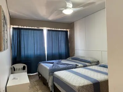 Uma cama ou camas num quarto em coberturas praia do futuro
