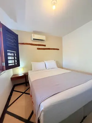 Uma cama ou camas num quarto em Pousada Calamarina