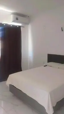 Uma cama ou camas num quarto em Pousada Residencial Manzuá