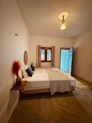 Uma cama ou camas num quarto em Lu Pousada Charme Preá