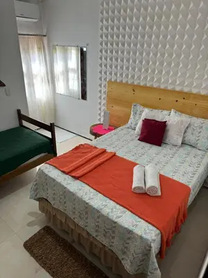 Uma cama ou camas num quarto em Pousada Delicias da vila