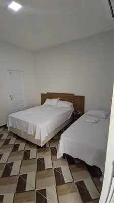 Uma cama ou camas num quarto em Pousada Garrida