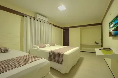Uma cama ou camas num quarto em Linda no BEACH PARK-16 pessoas - HOUSINGCEARÁ
