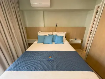 Uma cama ou camas num quarto em Studio Landscape Meireles Fortaleza