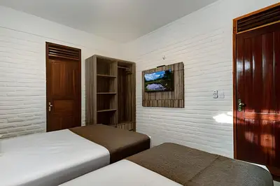 Uma cama ou camas num quarto em Aconchegante-8Suítes-28Pessoas - HOUSINGCEARÁ